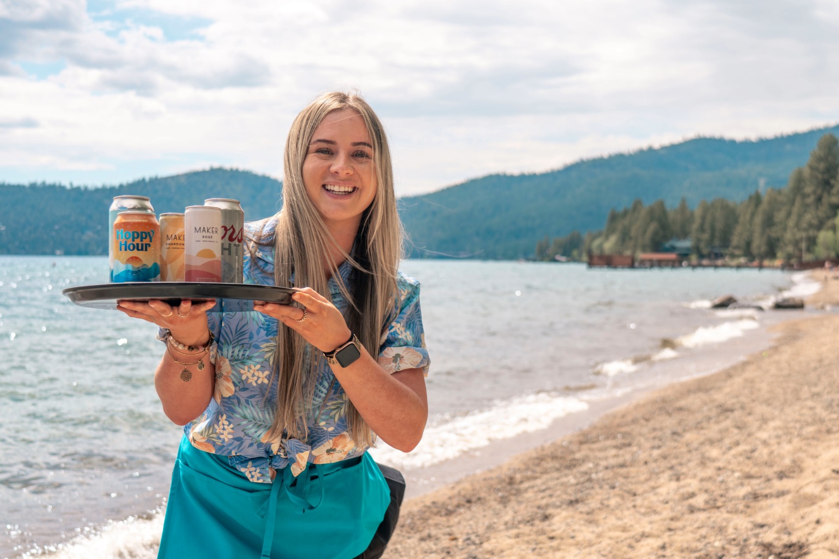 server on beach with canned drinks